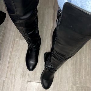 Black over the knee boots. Lightly worn. Side buckle feature. Great condition.